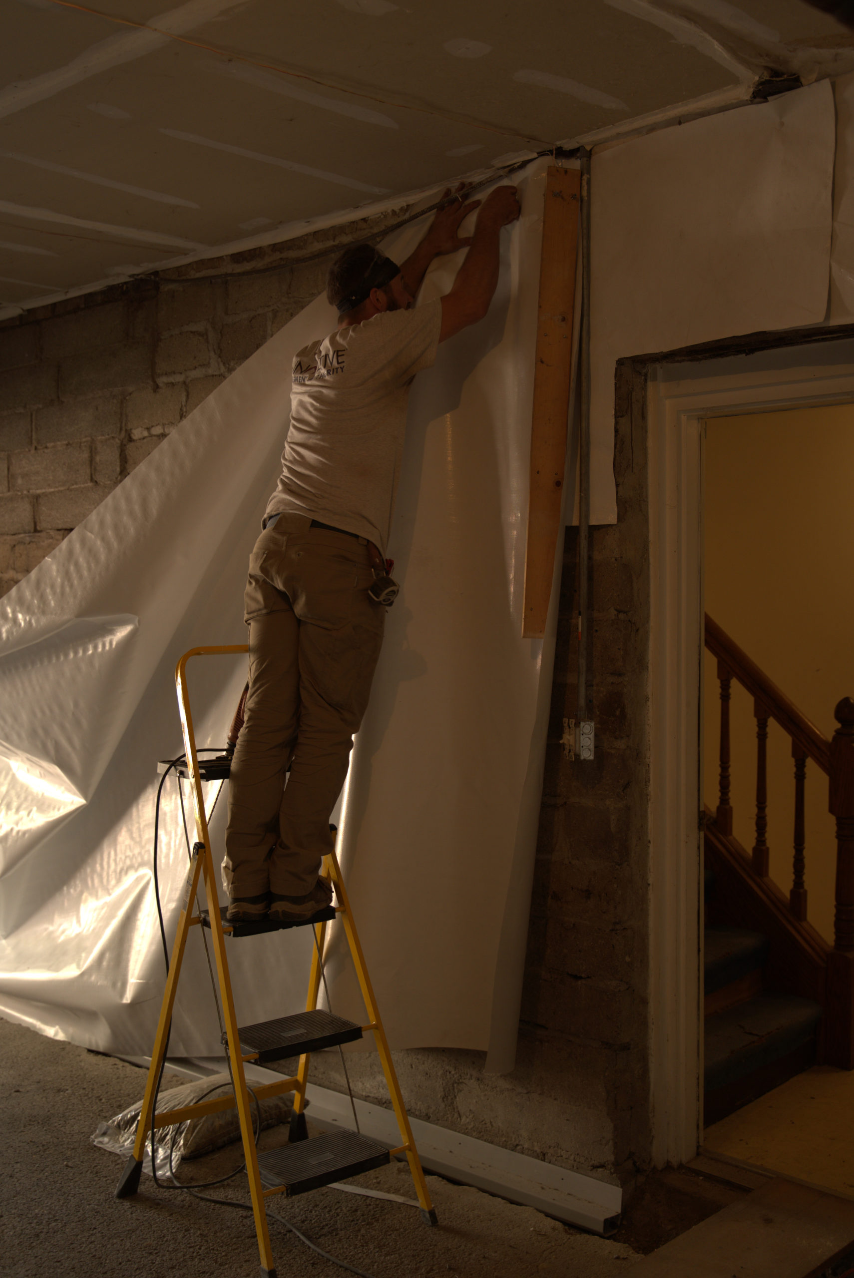 Crew installing WallSeal in basement